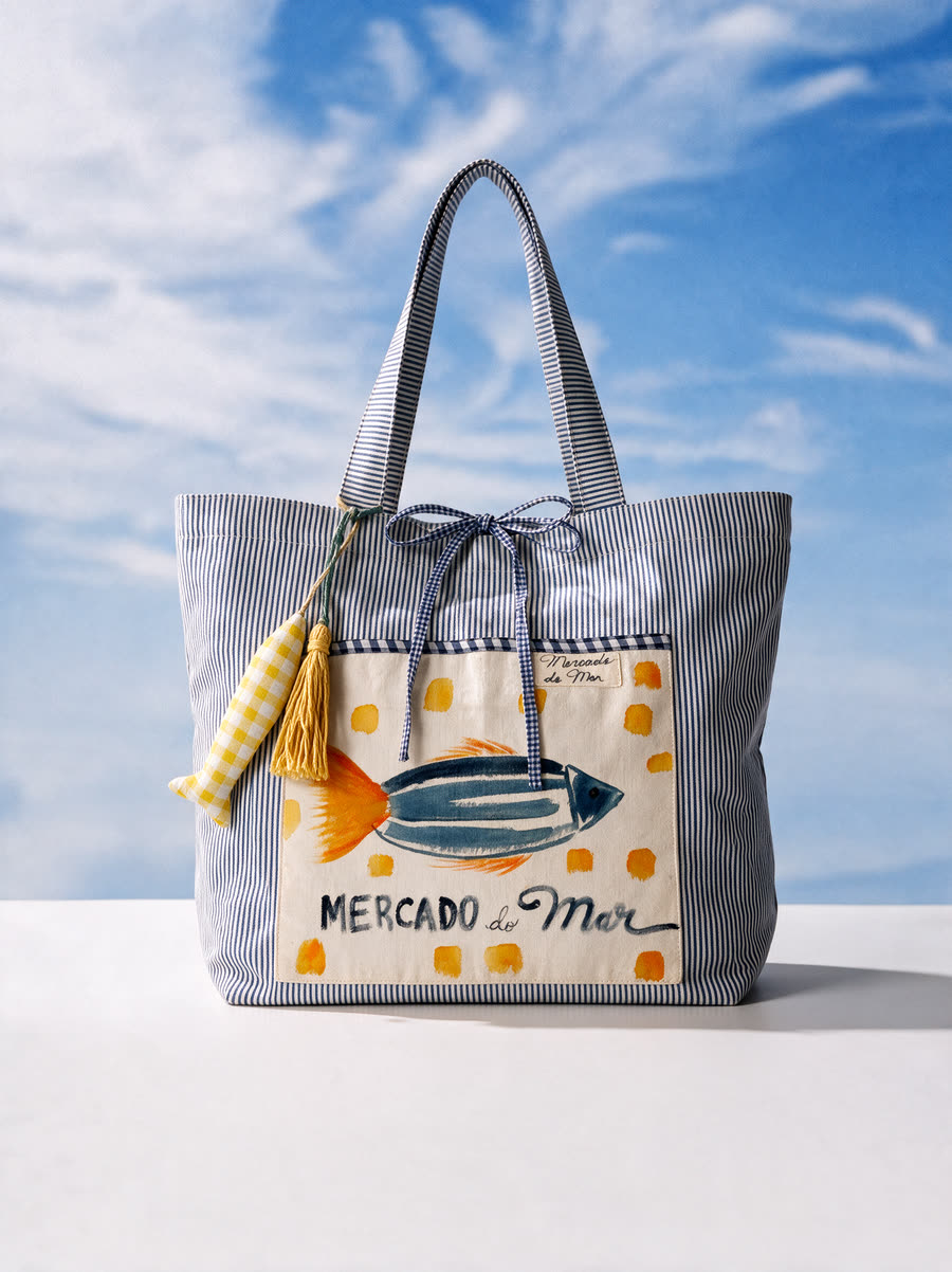 Bolsa O Dourado: peixe azul de cauda laranja entre bolinhas amarelas
